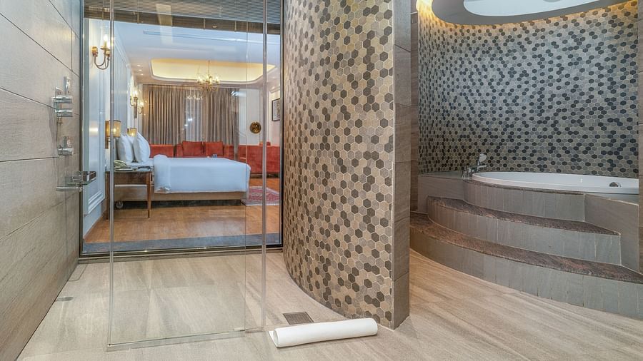An attached bathroom with a bathtub and elegant decor at our Two Bedroom Suite in Sringar - Sarovar Premiere, Srinagar